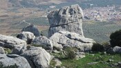 Large rocks overlooking a city and orchards