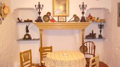 A nook with a mantle, a table and 4 chairs