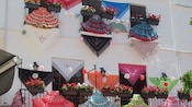 Balconies draped with dresses and flower beds