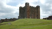A castle on a hillside in the near distance