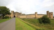 A paved, single lane road leading to Alnwick Castle