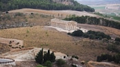 The ancient ruins of the Doric temple of Segesta stands amid rolling hills in Sicily, Italy