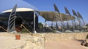An outdoor dining area at the Palma Aquarium featuring tables, chairs and shade
