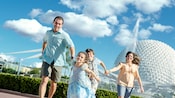 A little princess leads the charge as her family runs hand in hand in front of Spaceship Earth