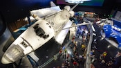 Adults and children observing Kennedy Space Center exhibits