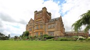 A 5 story country manor surrounded by gardens