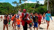 A pirate character leads a determined group of kids on a beach treasure hunt