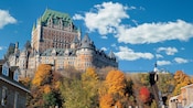 The large Chateau Frontenac with its castle like turrets stands high above rooftops and trees