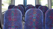 The interior of a vehicle reveals 10 seats in 3 rows