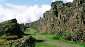 Guests walking along a wide footpath located between the Almannagjá and Heiðargjá faults in Iceland