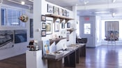 A gallery with paintings hanging on walls and one on an easel