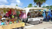 Tourists perusing the goods for sale in tented kiosks