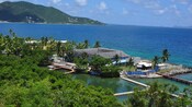 Boardwalks terminate at a square compound surrounded by the ocean on one side and a lagoon on the other