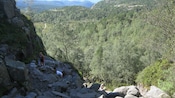 A couple of hikers climb the rocky path to the top of Pulpit Rock
