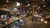 The interior of a general market reveals a lodge style decor and wares that include decorative throw pillows, candles, journals and other home furnishings