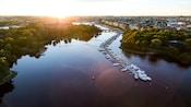 A dock crowded with boats in a waterway that runs through a city