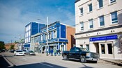 A main street with older buildings housing various businesses