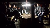 People wearing hard hats seated inside a mine