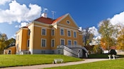 A grand baroque manor in a park like setting