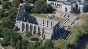 Vista aérea de las ruinas de un edificio de piedra sin techo, con ventanas altas en forma de arco