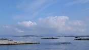 Several square wooden docks sit like islands on calm waters in a bay