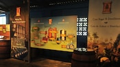 Posters hang in the Curaçao liquer distillery near oak barrels and illustrate the distilling process