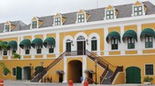 One of Willemstads colorful, Dutch colonial buildings features window awnings and a Caribbean feel
