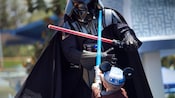 A little boy battles Darth Vader at the Jedi Training Academy