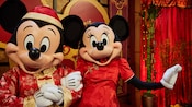 Mickey and Minnie dressed in festive costumes