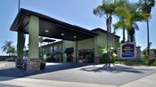 The carport overhang and entrance to Best Western Plus Pavilions accented with palm trees
