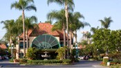 The main entrance to the classically styled Candy Cane Inn featuring a fountain and palm trees