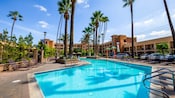 The large pool area has ample deck space, lounge chairs and palm trees