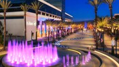 A sparkling fountain and winding stream at the Hilton Anaheim lit up at night