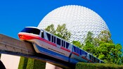 The monorail passing an attraction resembling a giant sphere called 'Spaceship Earth'