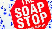 Stop sign-design laundry sign that states 'The Soap Stop, Vending Center'