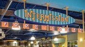 Vibrant signage featuring a series of musical notes near the entryway to the Intermission Food Court