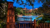 The Uzima Pool area at Disney's Animal Kingdom Lodge, lit up at night