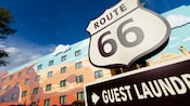 A 'Guest Laundry' sign below a shield-like sign for 'Route 66'