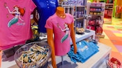 Ariel t-shirt on a mannequin torso in merchandise display area of a mini-market