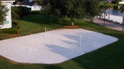 Overhead view of a white-sand volleyball court