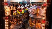 Assorted plush keychains from Mickey Mouse to Winnie the Pooh on a hanging display