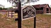 A wooden sign for the Tri-Circle-D Ranch