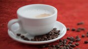 Un cappuccino près de grains de café