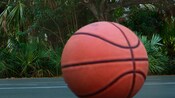 A basketball sits on the court