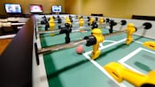 Close-up of a foos ball table with black and yellow 'men'