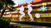 Giant cut-outs of a man and woman doing the 'twist' adorn the side of Disney's Pop Century Resort