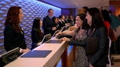 Cast Members assist Guests at the Lobby Concierge desk