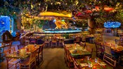 Simulated rain showers and fog add to the dining experience for patrons at Rainforest Café at Disney's Animal Kingdom Resort