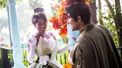 Princess Tiana and Prince Naveen under a flowery gazebo