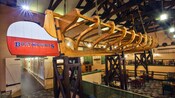 Large wooden hull of a fishing boat suspended from the ceiling at Boatwrights Dining Hall